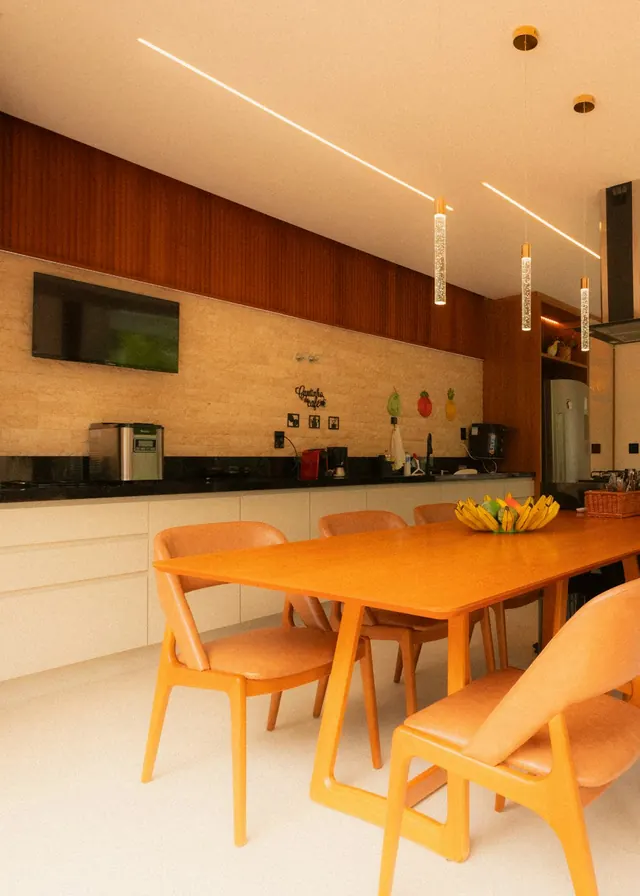 Shared kitchen and dining area with a long wooden table