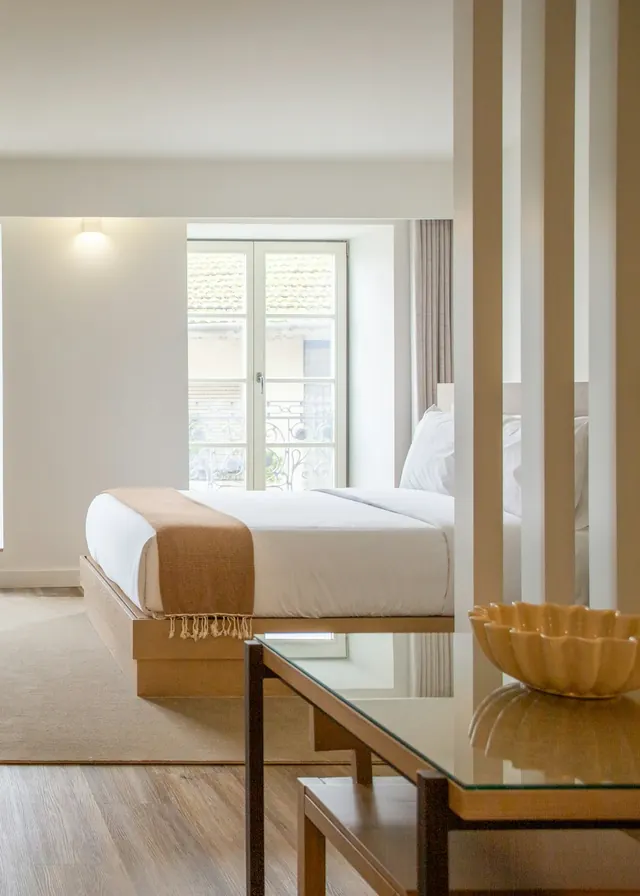Bright hotel room in cream and wood tones