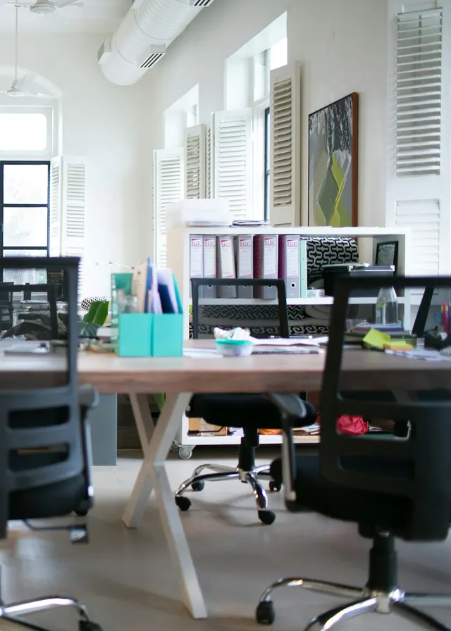 Open-plan office with workstations and large windows